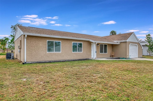 single story home with a front yard, a garage, and cooling unit