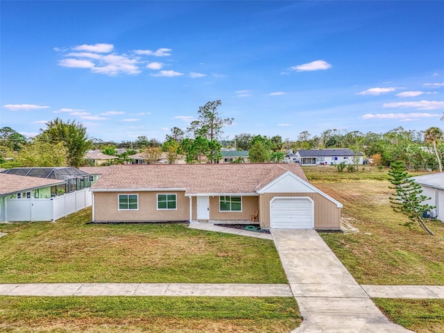 ranch-style home featuring a garage and a front lawn