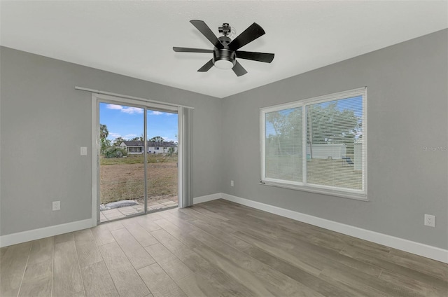 spare room with light wood-type flooring and ceiling fan