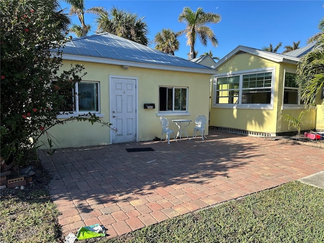 back of house with a patio