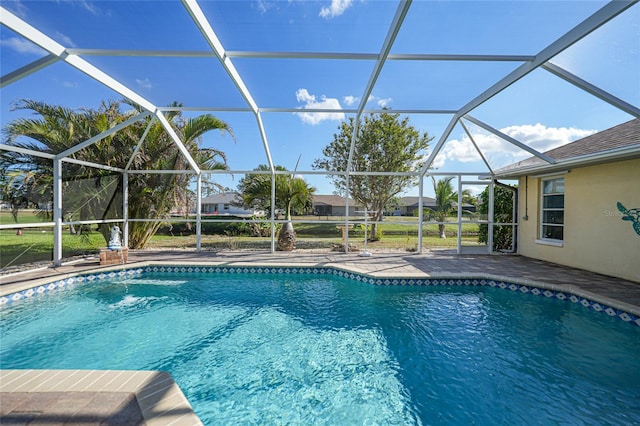 view of swimming pool with glass enclosure and a patio