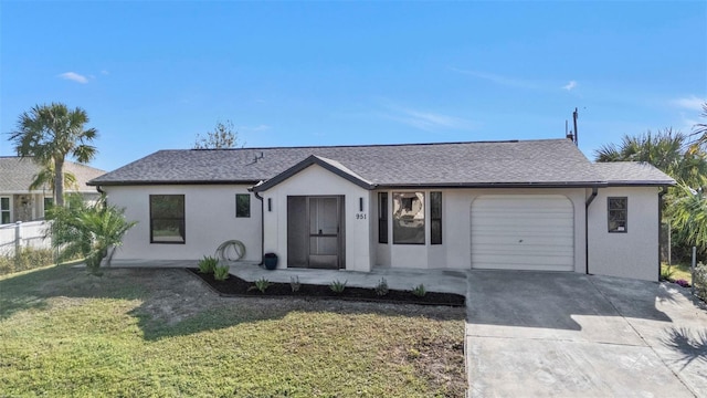 ranch-style house with a garage and a front lawn