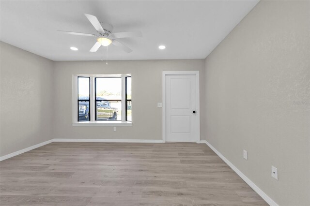 empty room featuring ceiling fan and light wood-type flooring