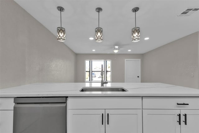 kitchen featuring stainless steel dishwasher, white cabinets, light stone countertops, and sink