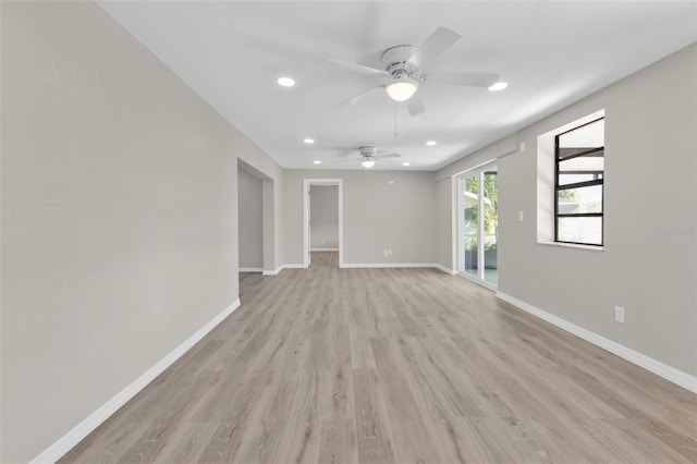 empty room featuring ceiling fan and light hardwood / wood-style flooring