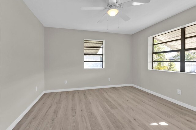 unfurnished room featuring ceiling fan, a healthy amount of sunlight, and light hardwood / wood-style flooring