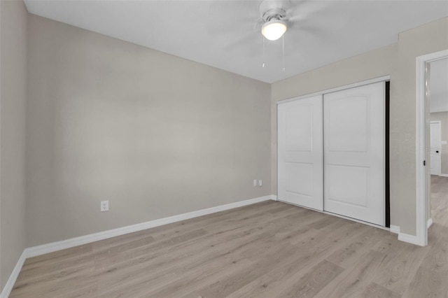 unfurnished bedroom featuring ceiling fan, a closet, and light hardwood / wood-style floors