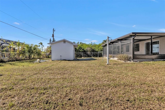 view of yard with a storage shed and a sunroom