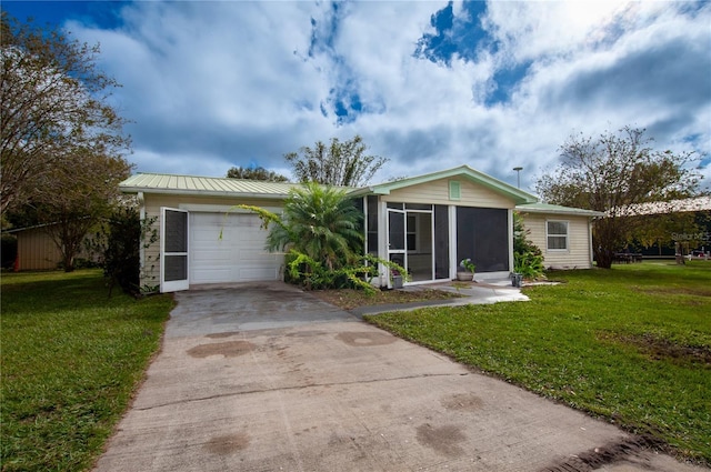 single story home with a garage, a front lawn, and a sunroom