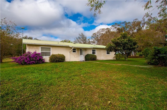 rear view of property featuring a yard