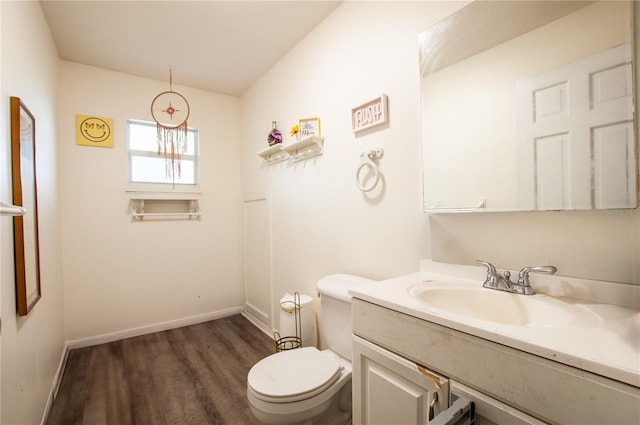 bathroom with hardwood / wood-style flooring, vanity, and toilet