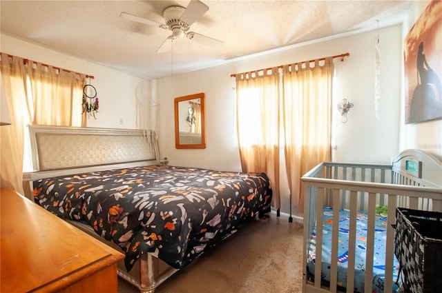 bedroom with carpet flooring, ceiling fan, and a textured ceiling