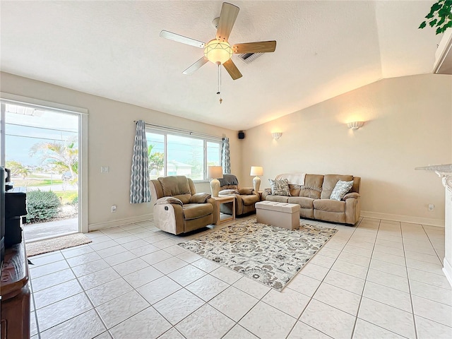 living room featuring ceiling fan, light tile patterned flooring, and vaulted ceiling