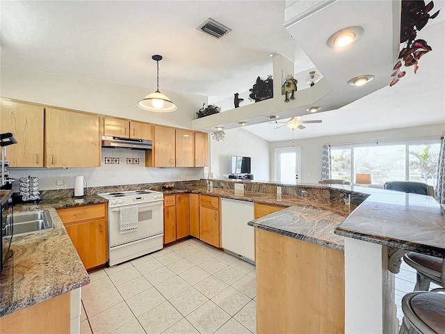 kitchen with pendant lighting, lofted ceiling, white appliances, ceiling fan, and kitchen peninsula