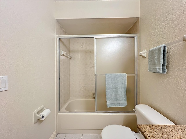 bathroom with tile patterned flooring, enclosed tub / shower combo, and toilet