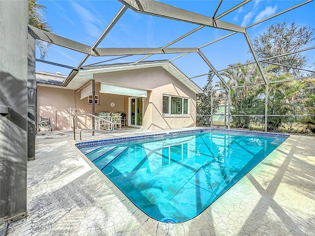 view of swimming pool featuring a lanai and a patio area