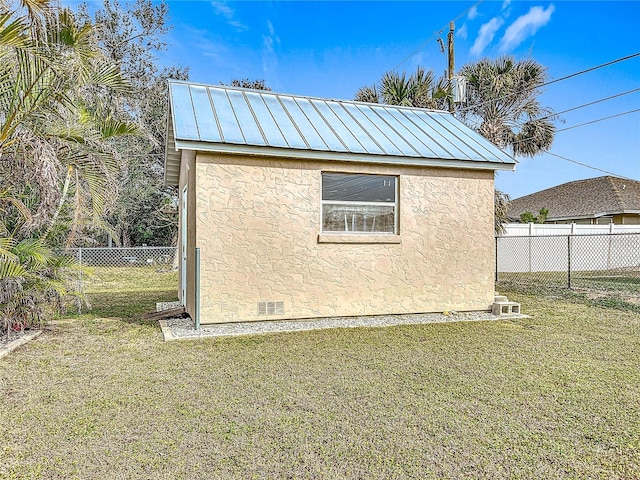 view of property exterior with an outbuilding and a yard