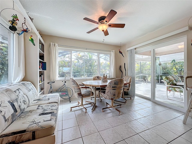 dining room with ceiling fan, light tile patterned floors, and a textured ceiling