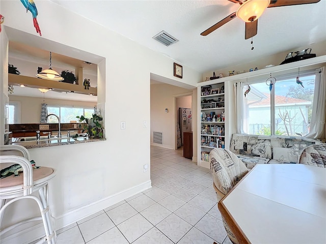 interior space featuring ceiling fan and light tile patterned flooring