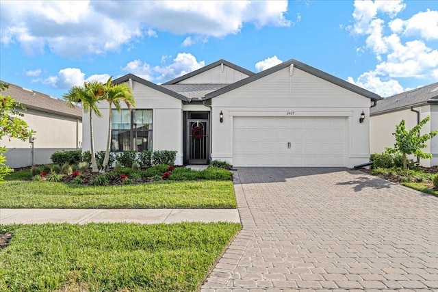 view of front of home featuring a front yard and a garage