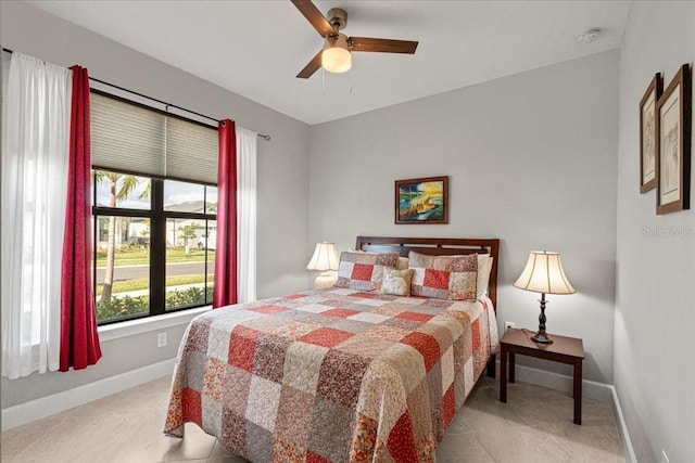 tiled bedroom featuring ceiling fan