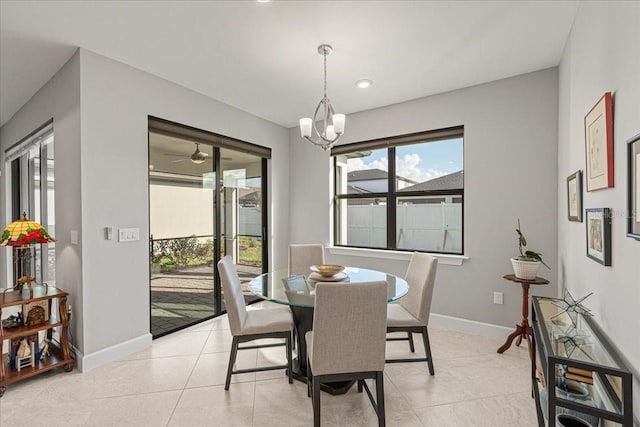 dining area featuring light tile patterned floors and an inviting chandelier