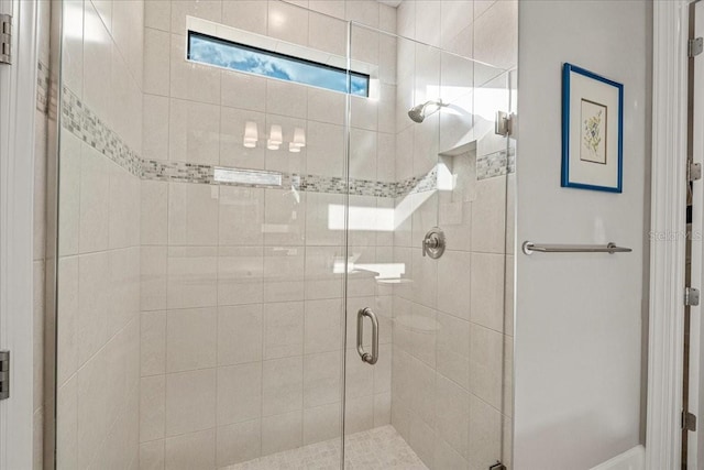 bathroom with a shower with shower door