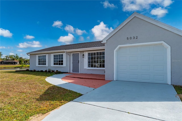 ranch-style house with a front yard and a garage