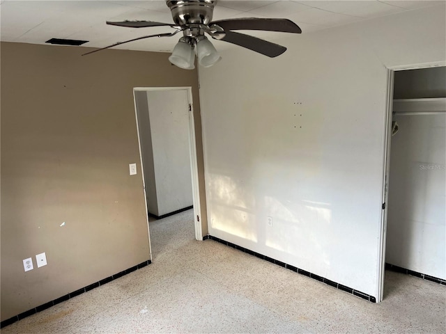 unfurnished bedroom featuring ceiling fan and a closet