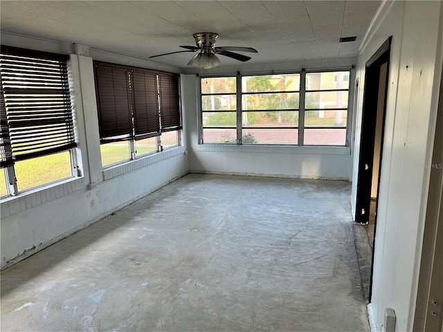 unfurnished sunroom with ceiling fan