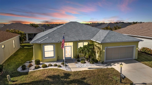 view of front of house with a lawn and a garage