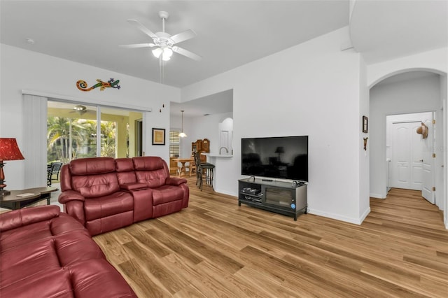 living room featuring ceiling fan and hardwood / wood-style floors