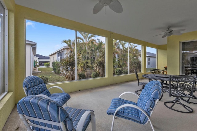 sunroom featuring ceiling fan