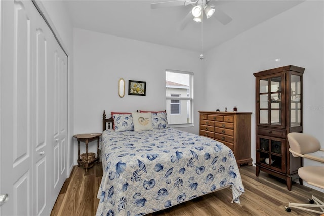 bedroom featuring wood-type flooring, a closet, and ceiling fan