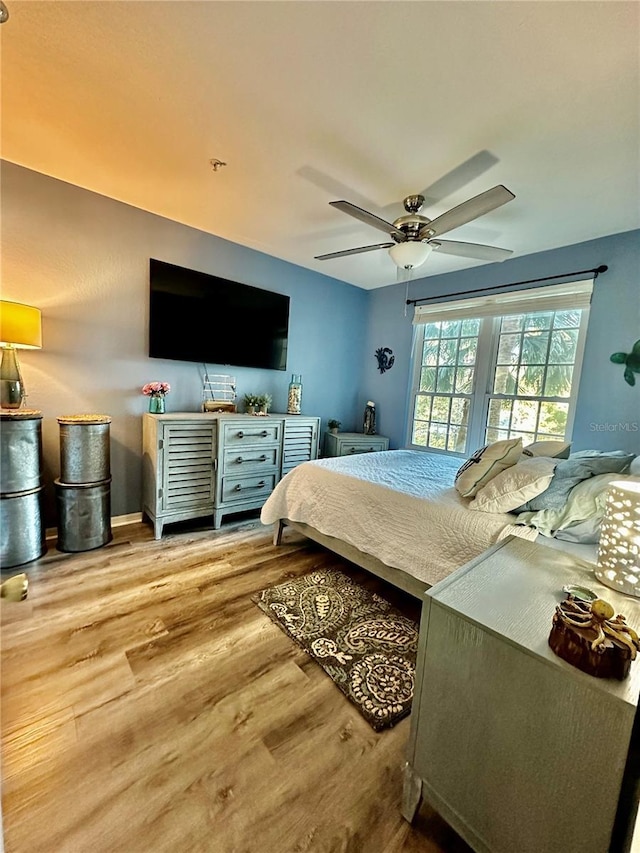 bedroom with hardwood / wood-style floors and ceiling fan