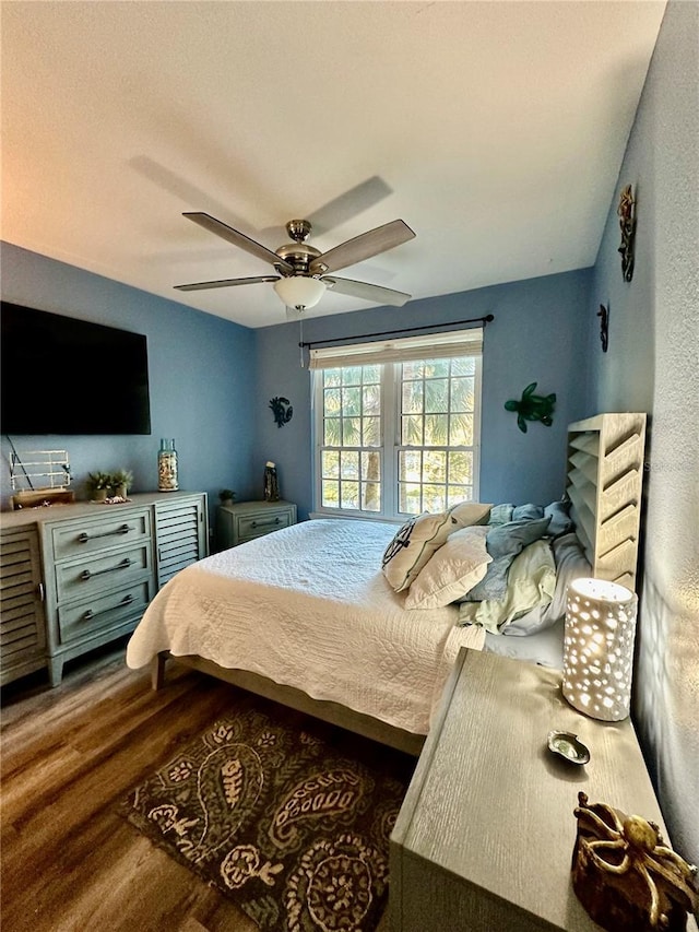 bedroom with wood-type flooring and ceiling fan