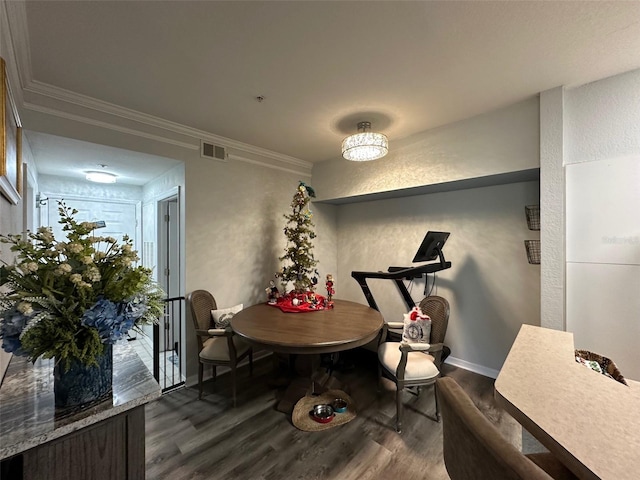 dining space with a textured wall, visible vents, baseboards, dark wood-style floors, and crown molding