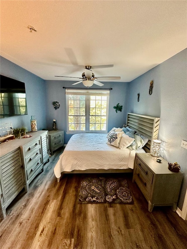 bedroom with ceiling fan and wood finished floors