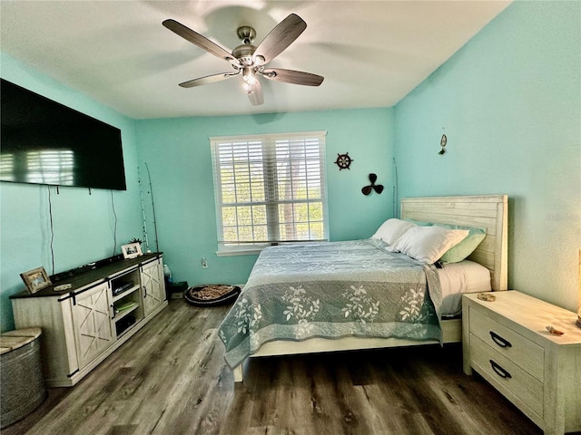 bedroom with dark wood-type flooring and a ceiling fan