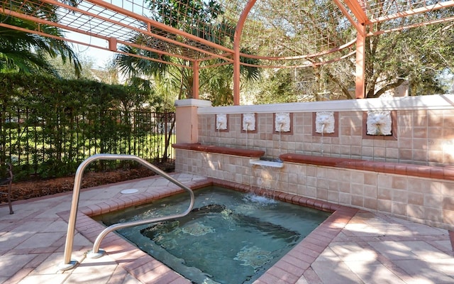 view of swimming pool with fence and an in ground hot tub