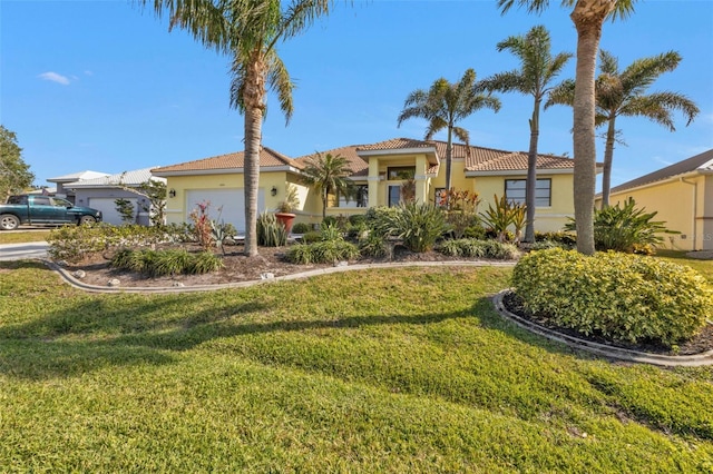 mediterranean / spanish house with a garage and a front yard