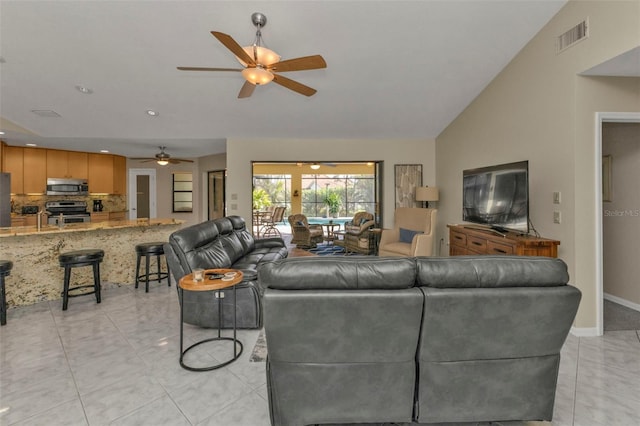 tiled living room with vaulted ceiling and ceiling fan