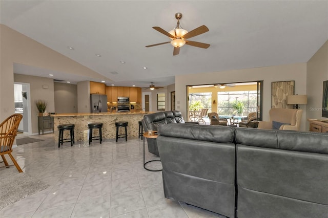 living room with light tile patterned floors and vaulted ceiling