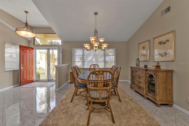 dining space with light tile patterned floors, an inviting chandelier, and lofted ceiling