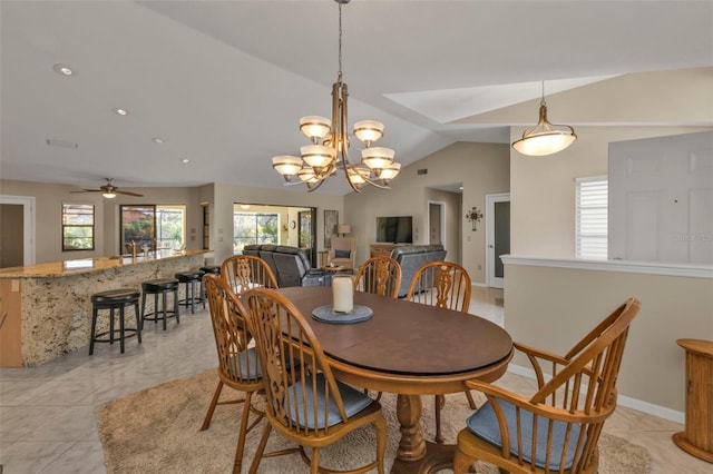 dining space featuring ceiling fan with notable chandelier, lofted ceiling, and light tile patterned flooring