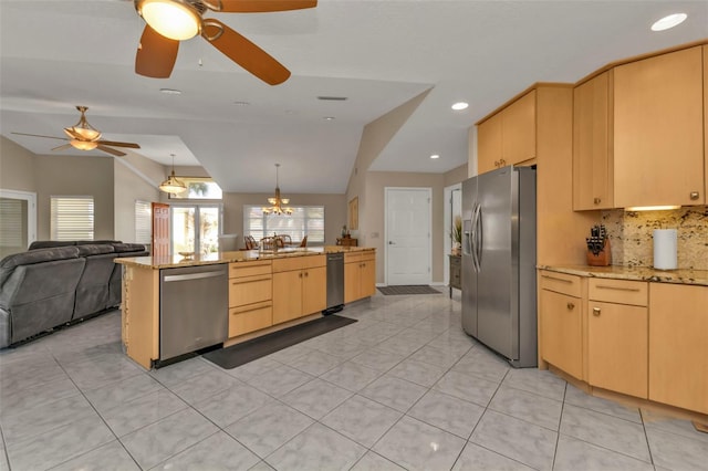 kitchen with light brown cabinets, stainless steel appliances, tasteful backsplash, lofted ceiling, and light tile patterned floors