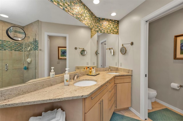 bathroom featuring toilet, tile patterned flooring, vanity, and walk in shower