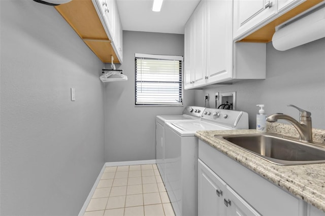 washroom featuring cabinets, light tile patterned floors, sink, and washing machine and clothes dryer