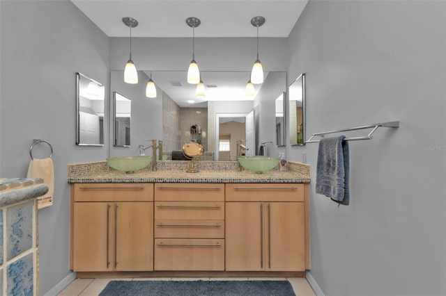 bathroom featuring a shower, tile patterned flooring, and vanity