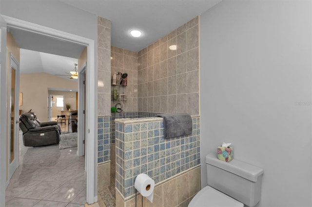 bathroom with ceiling fan, toilet, a shower, and vaulted ceiling